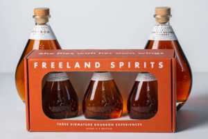 Three small bottles of Freeland Spirits bourbon in a package.
